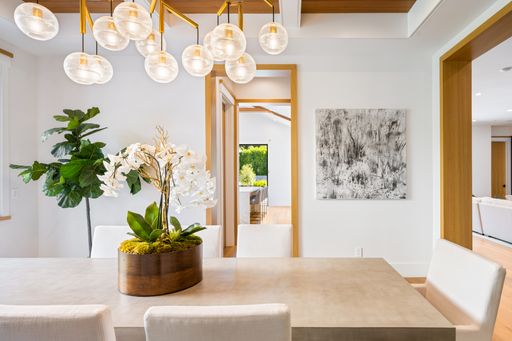 White chair and wooden table in a cozy dining room