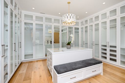 Modern bathroom with white cabinets and stylish wooden floors