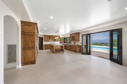 A residential interior featuring wooden cabinets, a spacious window, and an indoor swimming pool
