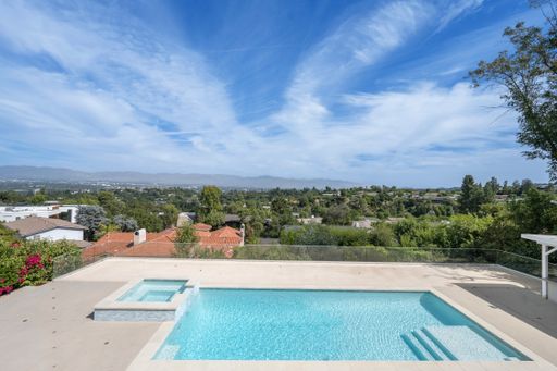 A contemporary pool with scenic valley and hill views in Encino, California