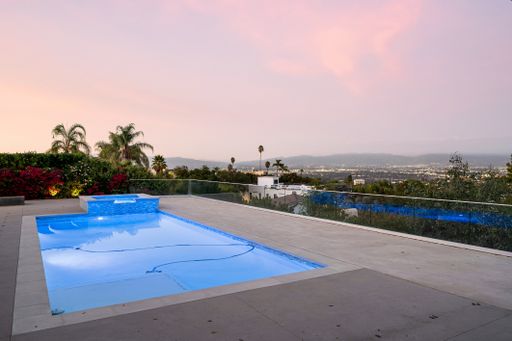 An outdoor pool overlooking a town in Encino, California