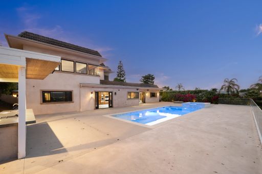 A concrete house with backyard pool in California
