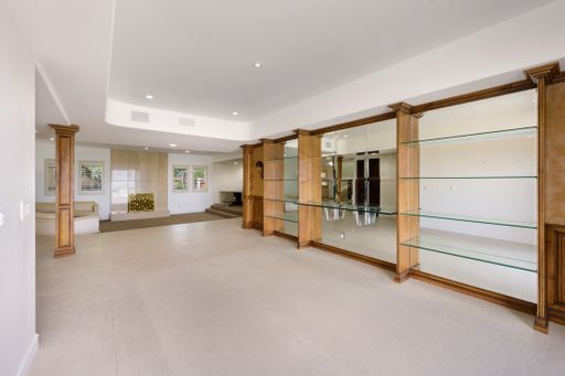 A spacious interior with glass shelves and wooden floor in California
