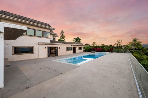 Contemporary home with adjacent pool in backyard, California