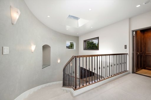 An inviting entrance to a beautiful home with a charming stairway in California