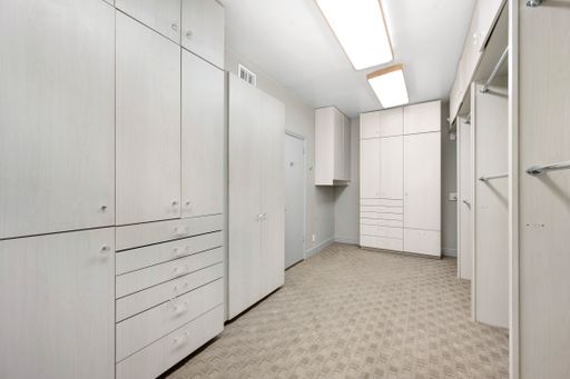 A home closet with cupboards and shelves in California