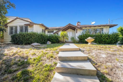 A backyard house entrance with stairs leading to the front door in Hidden Hills, CA