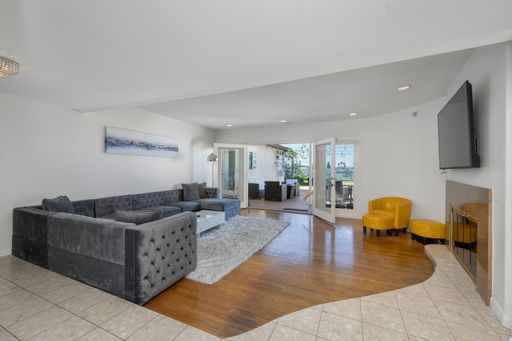 A contemporary living room with stylish furnishings and expansive ocean view through large windows
