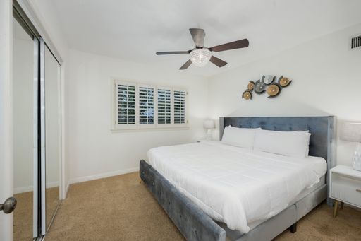 A bedroom with two beds and blinds in Hidden Hills