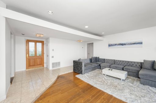 A living room with a sofa, coffee table, and doors in Hidden Hills, CA