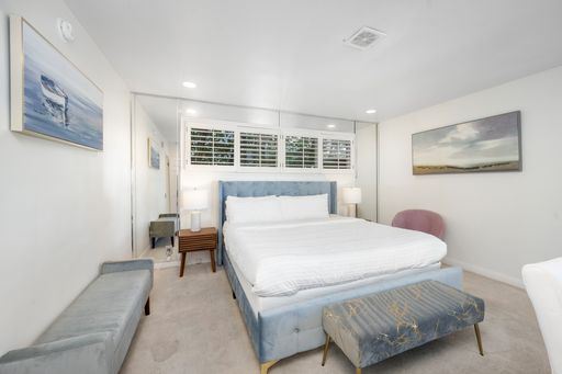 A cozy room with a sofa, bed, and dresser in Hidden Hills, CA