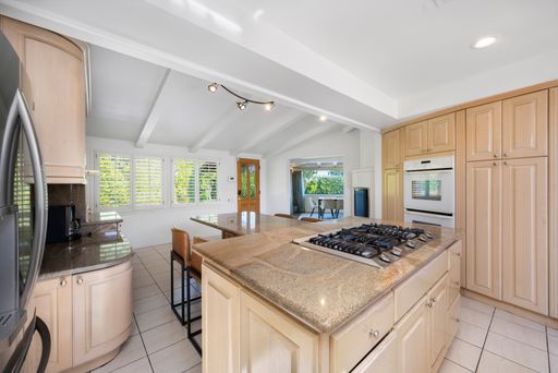A kitchen featuring wooden cabinets and countertops in Hidden Hills, CA