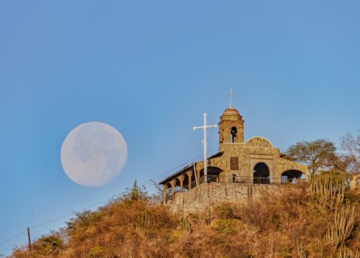 View perspective landscape of a mountain with a church and the full moon in the background