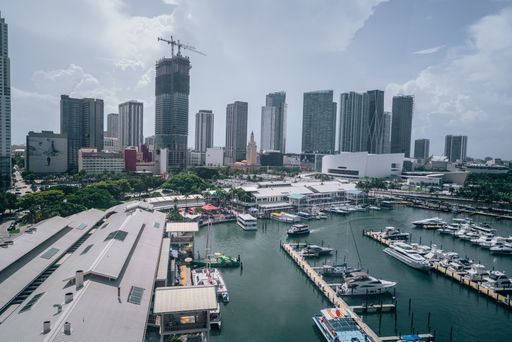 A beautiful scenery of large harbor full of ships and yachts with blue cloudy sky