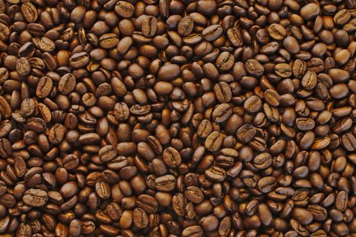 A beautiful closeup shot of brown fresh black coffee beans - perfect background or wallpaper