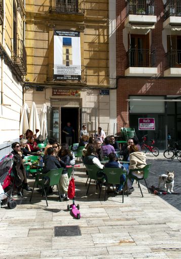 A street scene in the old Spanish city of Murcia.  Despite the Corona virus epidemic, ordinary life continues much as before.   People enjoy the sun.