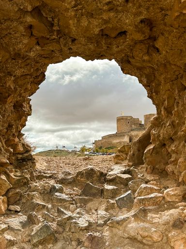 The view of Castillo de Consuegra seen through a rock arch. Spain