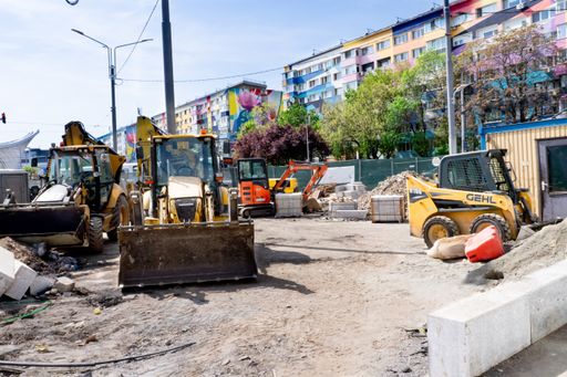 The bulldozers by concrete barriers at Bucharest construction site, Romania