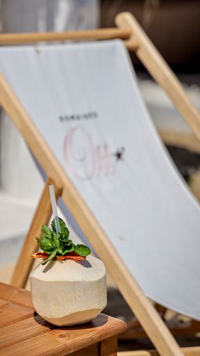 A selective focus shot of fresh coconut drink with drinking straw