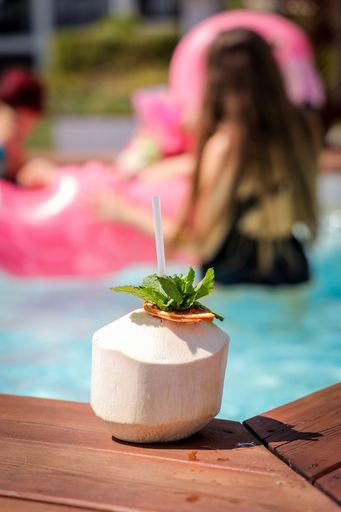 A selective focus shot of fresh coconut drink with drinking straw