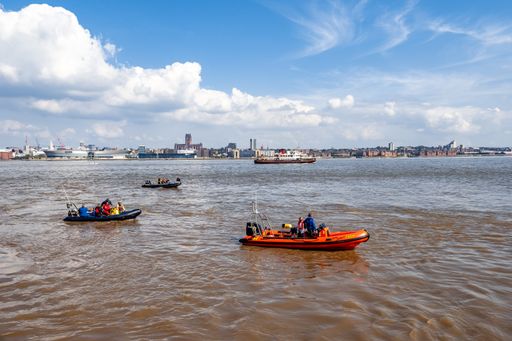Liverpool Merseyside UK 06 April 2024. 4 Inflatable Rib boats in the water with famous Mersey ferry boat behind and Liverpool skyline.