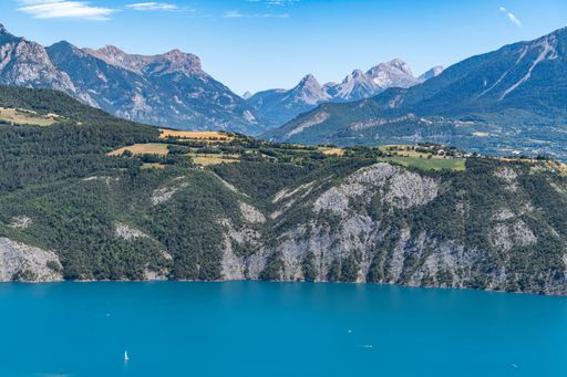 Lake of Serre-Poncon during summer, surrounded by beautiful alpine landscape, Hautes-Alpes, France