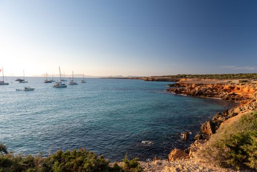 A scenic view of boats on the beach of Cala Saona in Formentera, Spain