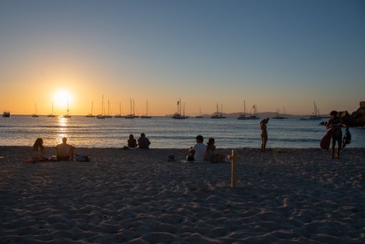Formentera, Spain: 2021 June 23: Young people enjoy the sunset on the beach in Cala Saona in Formetera in summer 2021