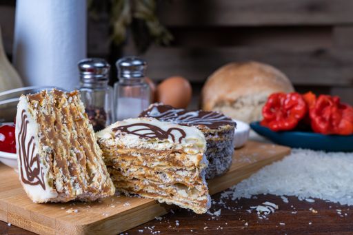 Two freshly baked cakes with different toppings on the table with baking ingredients on the background