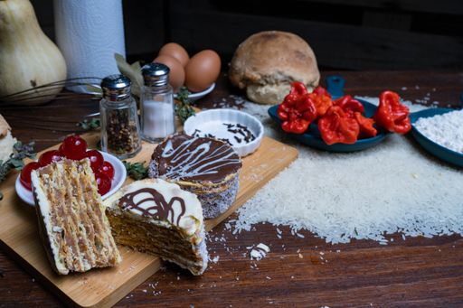 A closeup of delicious fresh pastries with ingredients on a wooden board on the table in the kitchen