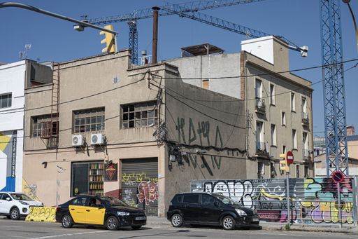 Barcelona, ​​Spain; June 15, 2021: Abandoned building in the city and cars passing