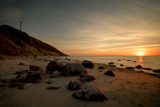 A scenic sunset at the Baltic sea under wispy clouds