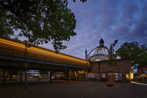 Berlin; Germany - June 23; 2021: Night shot at Nollendorfplatz subway station with a rainbow-colored dome on the occasion of Christopher Street Day.