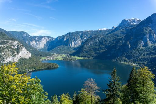 A high angle shot of the Hallstatt lake surrounded by high rocky mountains in Austria
