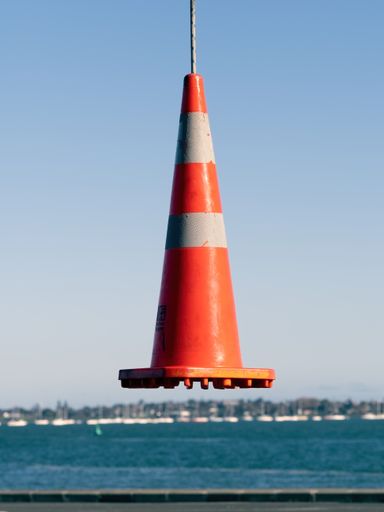 View of road cone hanging in the air. Auckland, New Zealand - June 21, 2021