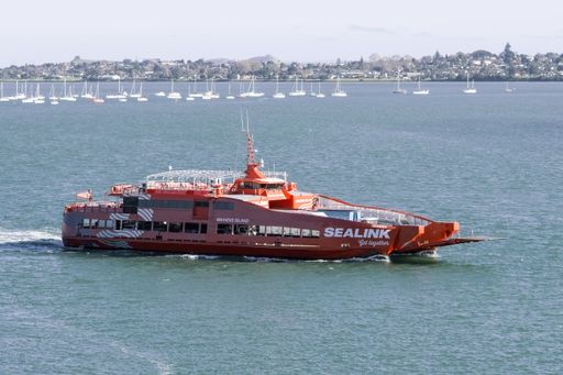 Aerial view of Sealink passenger car ferry riding to Waiheke island from Half Moon Bay. Auckland, New Zealand - June 21, 2021