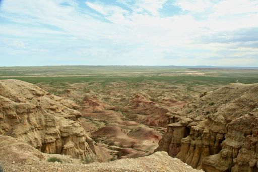 A wide angle shot of a large landscape of rocks under a clouded sky
