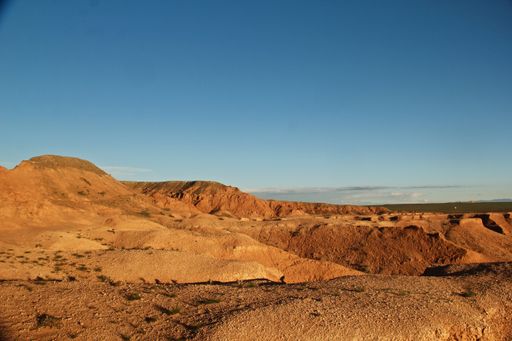 A wide angle shot of the mountains under a blue sky