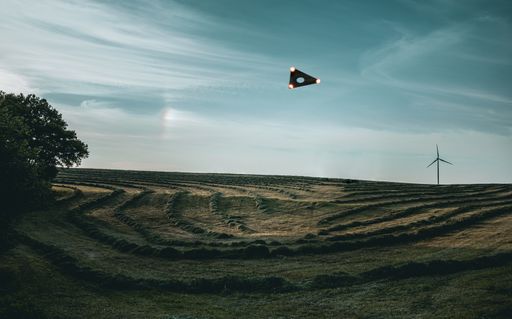 A panoramic shot of an unidentified flying object over the landscape field
