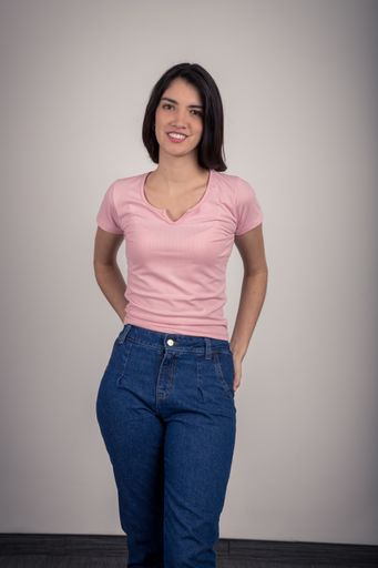 A vertical shot of a young female in pink with short hair posing on an isolated gray background