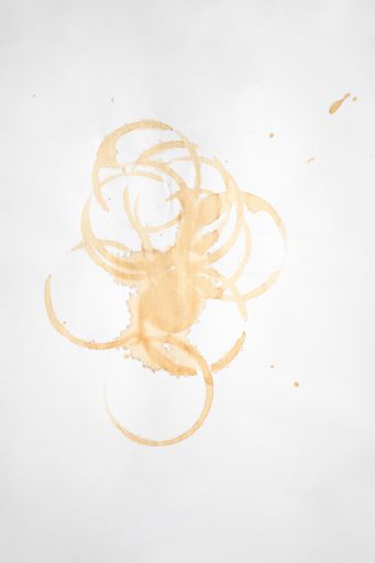 The white paper with brown ink splatter stains
