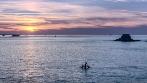 A sunset sky reflecting over the water in Saint-Malo, Brittany, France