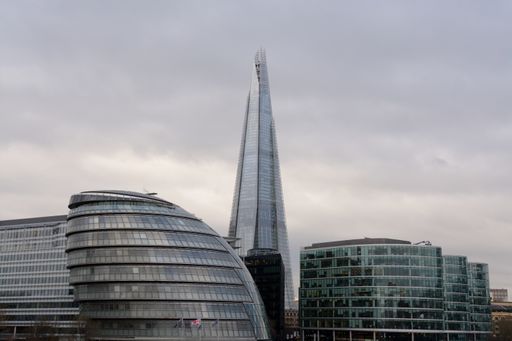 A tall glass building in the distance in London