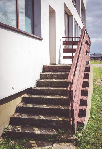 A vertical shot of stone steps leading to building entrance