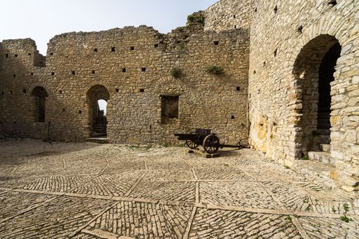 A low angle closeup shot of walls and the ground of the Caccamo Castle in Sicily, Italy