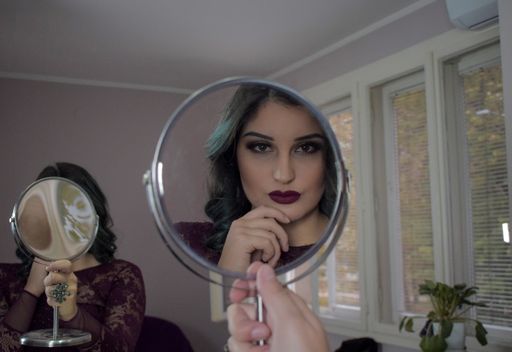 Creative shots of a goth girl looking at herself in the mirror
