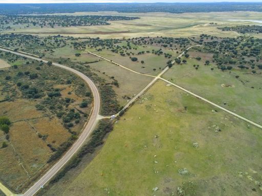 An aerial shot of roads in the middle of grassy fields in Salamanca, Spain