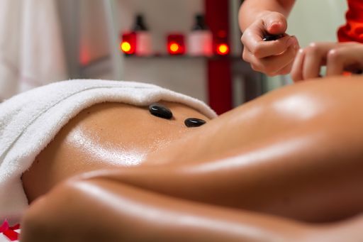 A female lying at a spa getting a massage