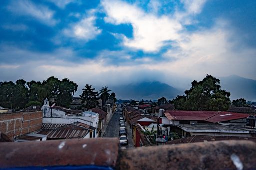 A high angle shot of the buildings in Antigua Guatemala under the cloudy sky
