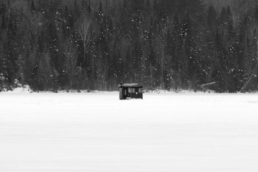 A small cabin in a snowy field